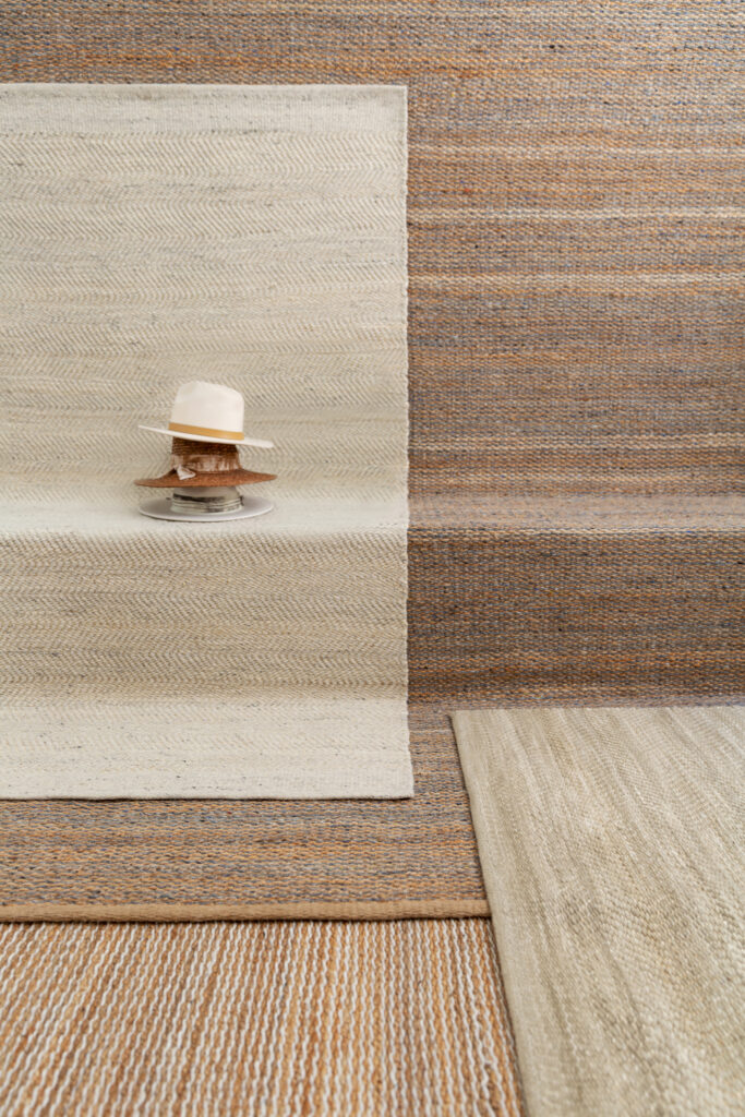 Four natural rugs layered on top of each other
