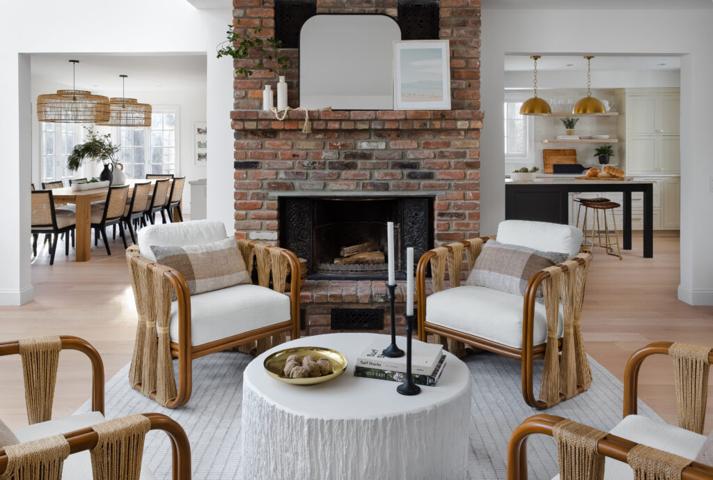 A seating area in front of a fireplace with neutral tone rug