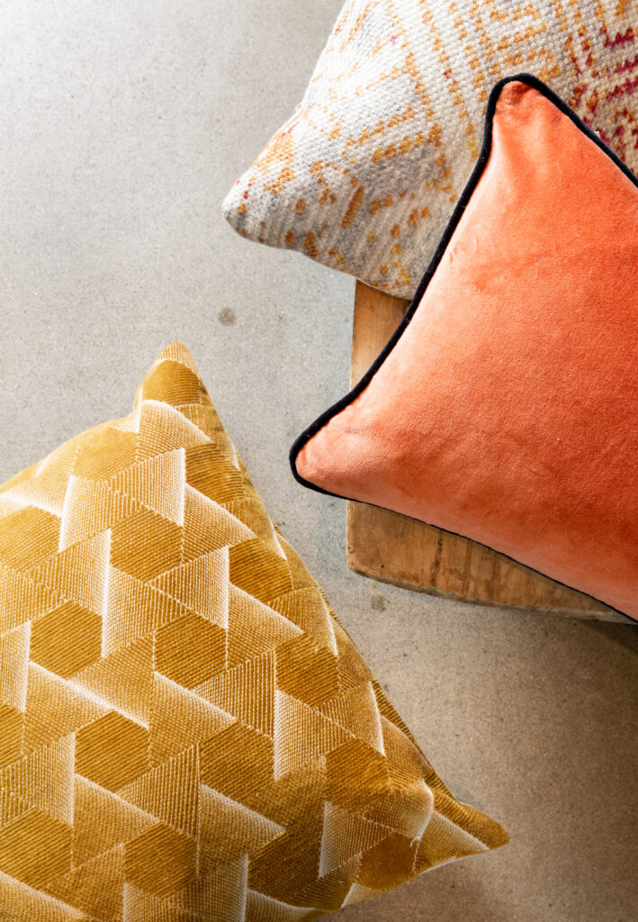 A grouping of yellow, cream, and orange pillows
